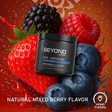 A jar of Sunmed CBD Beyond 1:1:1 Indica Live Resin Gummies, featuring strawberries, blueberries, raspberries, and a vegan-friendly label in the background.