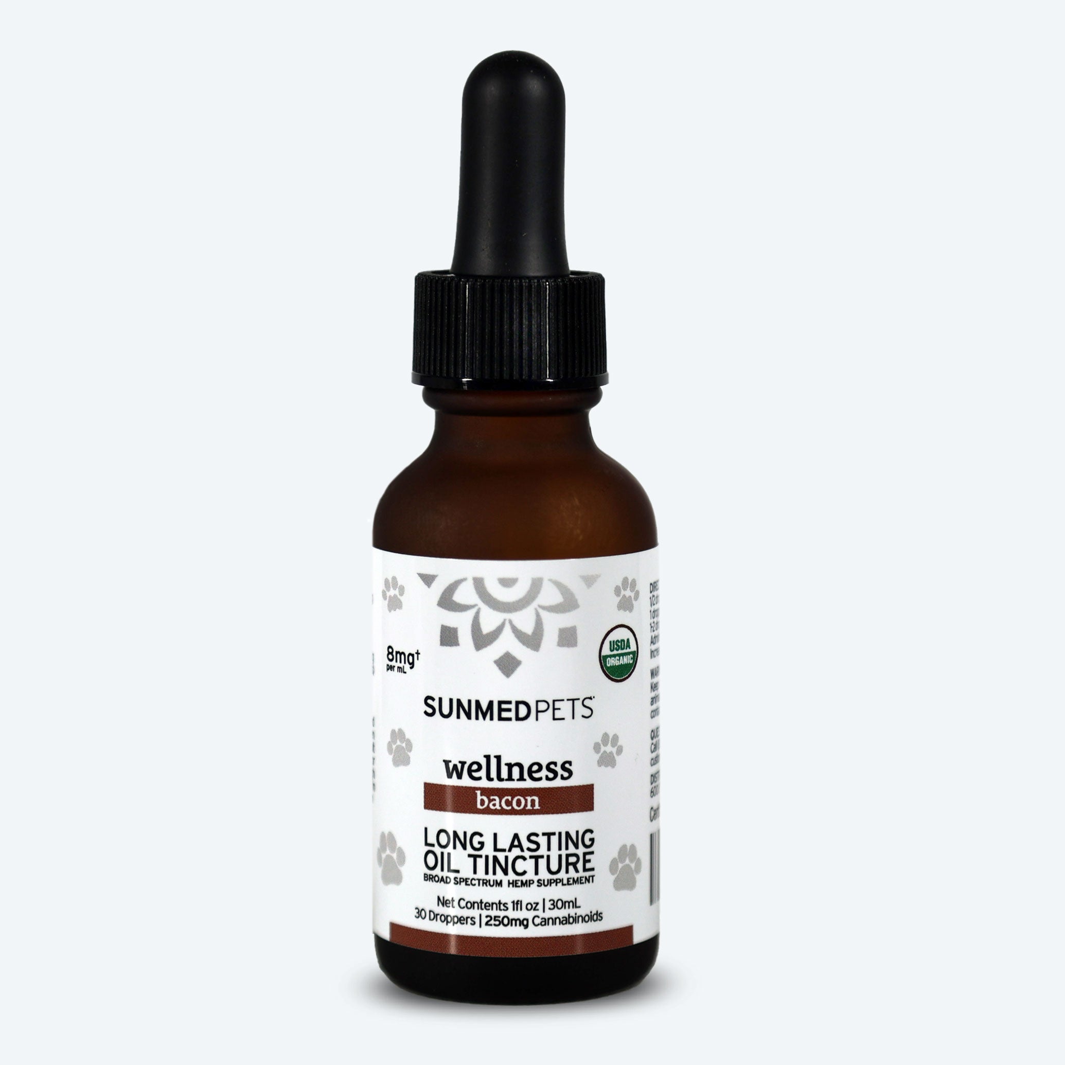 A brown dropper bottle labeled "Sunmed CBD Broad Spectrum CBD Pet Tinctures" contains an organic CBD oil tincture, ideal for dogs or cats.