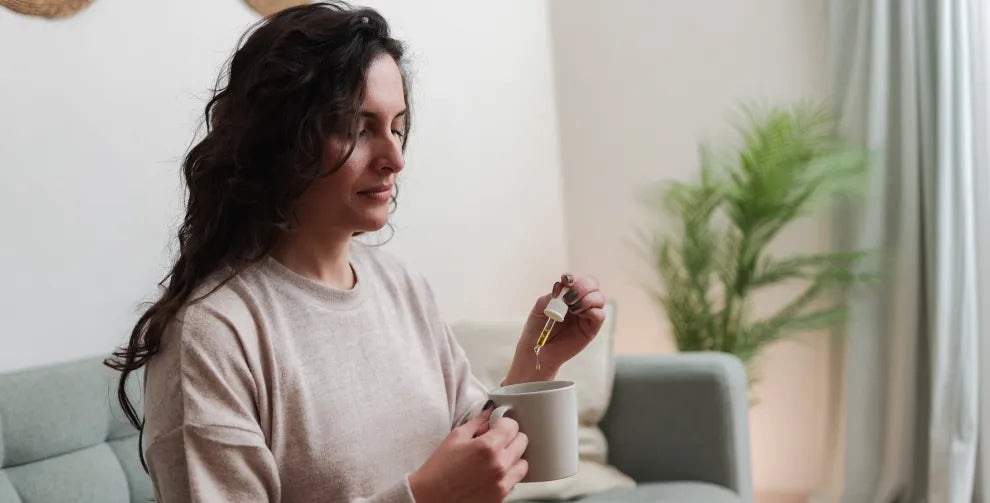 A woman taking cbd oil in the morning