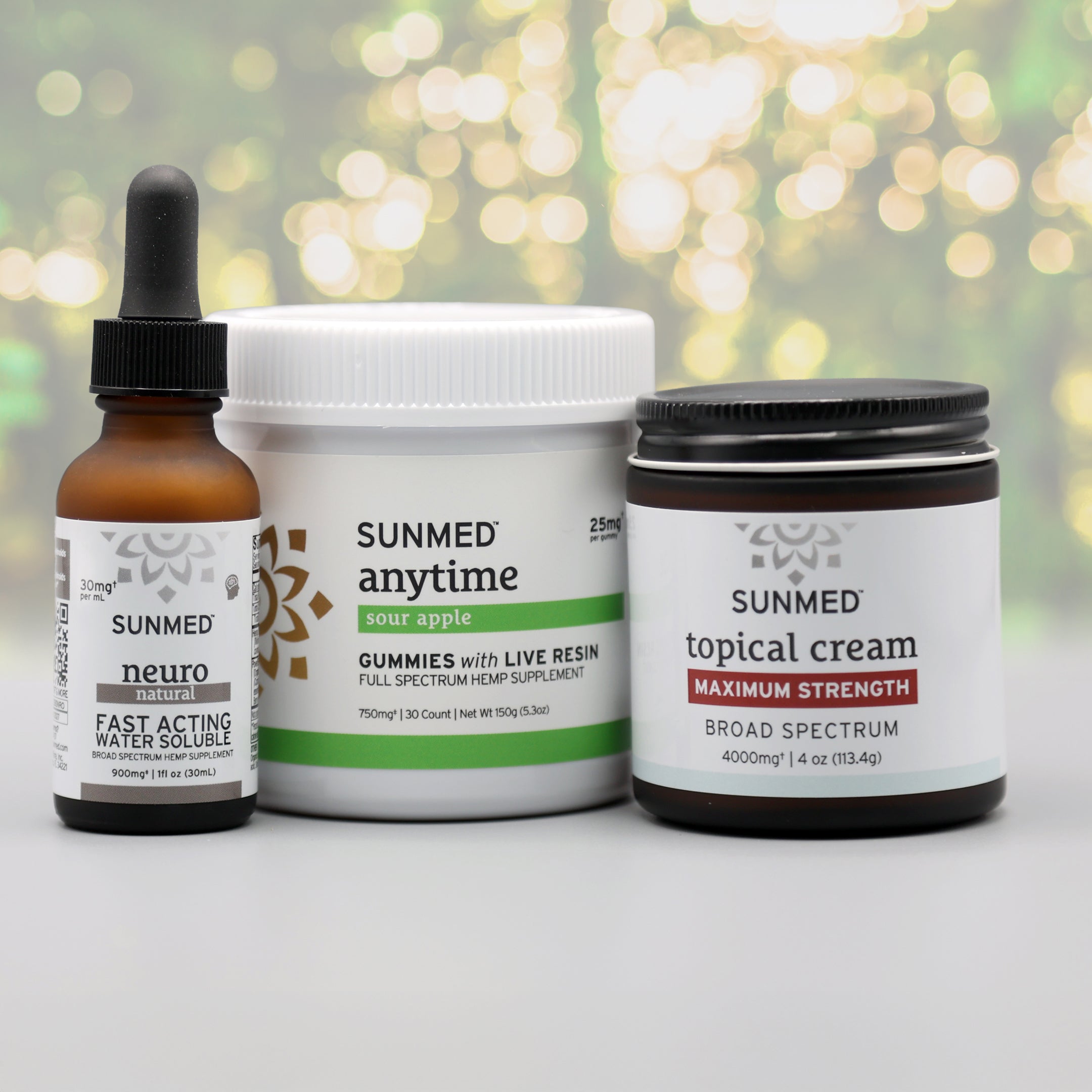 The Sunmed CBD Full Spectrum Anytime Gummies + Neuro Water Soluble + Topical Cream Bundle is displayed against a blurred background.