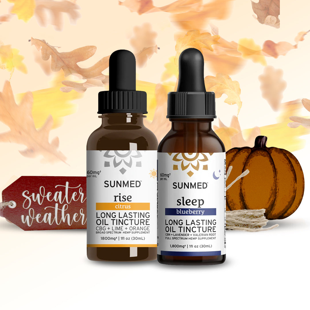 Two Sunmed CBD tincture bottles with fall leaves, a pumpkin, and a “sweater weather” sign in the background—perfectly showcasing the Full Spectrum Sleep + Rise Tincture Bundle, which pairs an energizing morning tincture with a calming sleep tincture to support your well-being around the clock.
