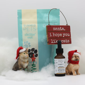 Two pet figurines in Santa hats with the Sunmed CBD Chillin&