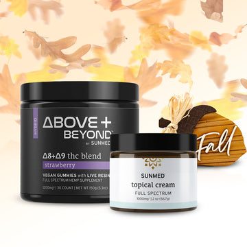 Two jars of Sunmed CBD products from the ABOVE + BEYOND Gummies + Topical Cream Bundle are displayed with fall leaves and a small wooden pumpkin that says “Fall” in the background. One jar features gummies, providing a delicious way to support your daily wellness routine this season.