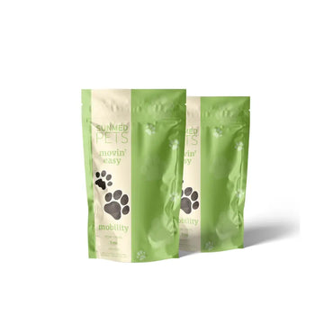 Two green and beige pet treat bags labeled “Sunmed CBD *20% Off* - Broad Profile Movin’ Easy Relief Hemp Pet Chews 2-Pack” with paw prints on the front.