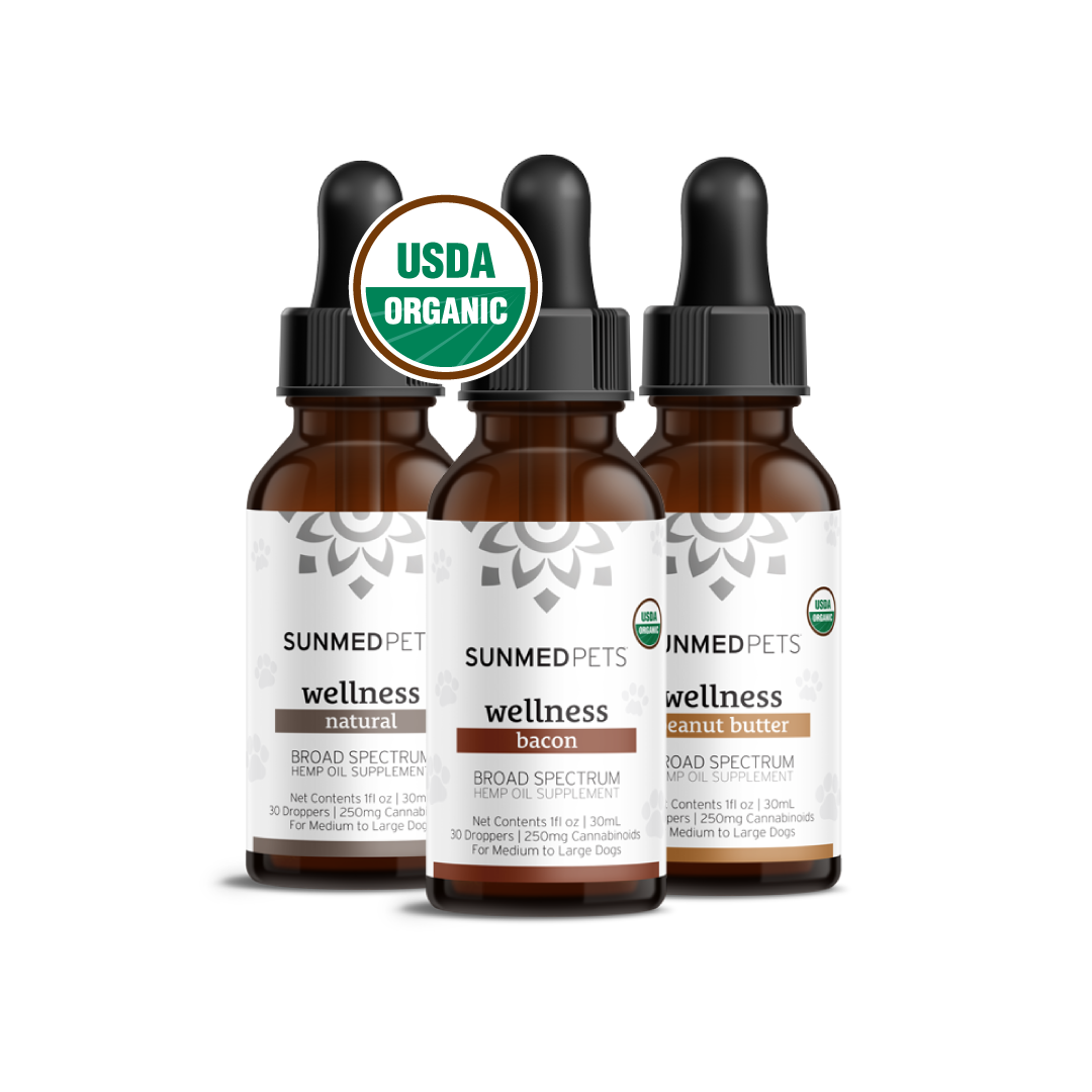 Three brown dropper bottles of Sunmed CBD's Broad Spectrum CBD Pet Tinctures for dogs come in natural, bacon, and peanut butter flavors, perfect for pet well-being. Each bottle carries the USDA organic label, ensuring high-quality organic CBD.