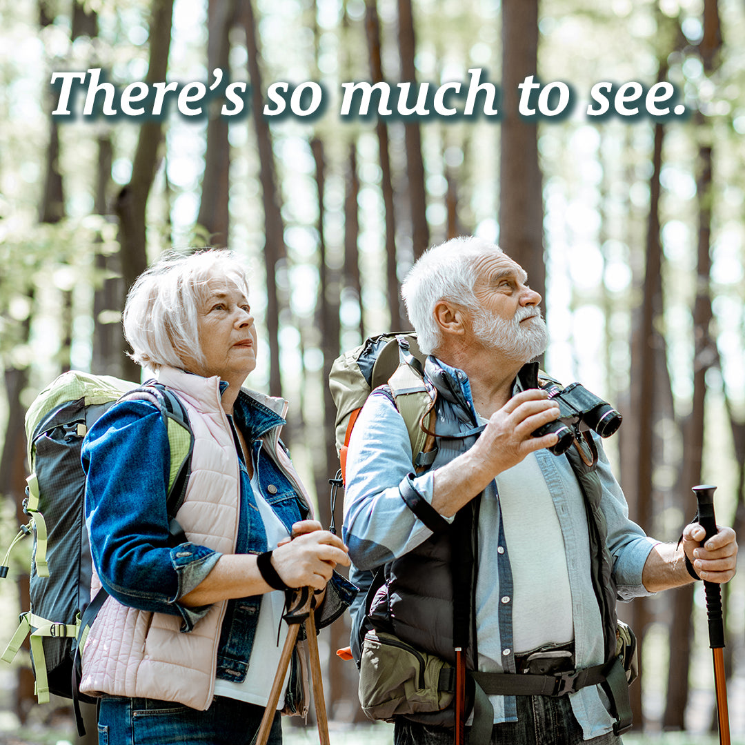Senior couple hiking with backpacks and binoculars, text reads "There's so much to see." Every step is easier with Sunmed CBD's Broad Spectrum Relief CBD Cream, featuring soothing hemp extract for targeted topical relief.