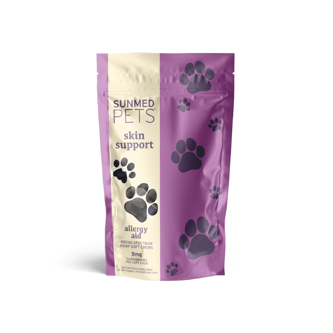 A purple and beige bag of Sunmed CBD's Broad Spectrum Allergy Aid Pet Chews with paw print designs, ideal for promoting skin health.