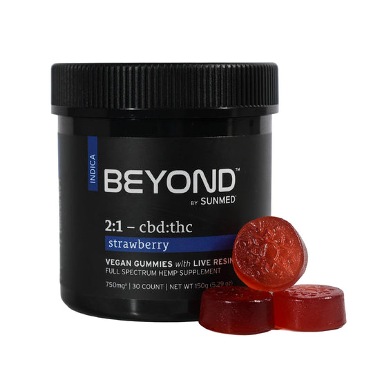A black jar of Sunmed CBD's Beyond 2:1 Indica Live Resin Gummies with three red gummies stacked in front—enjoy the ideal CBD to THC ratio and delicious flavor in these premium treats.