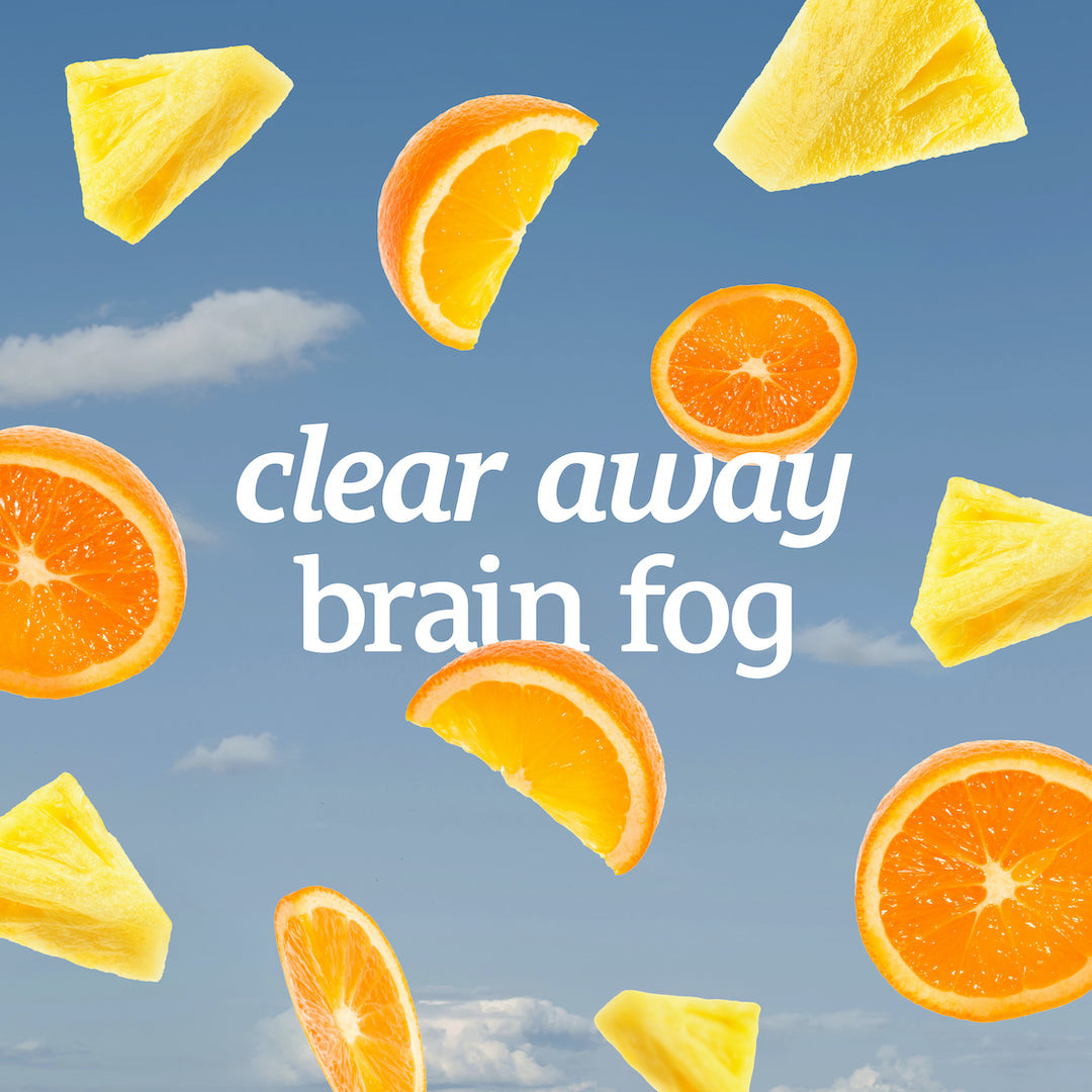 Sliced oranges and pineapples with the "clear away brain fog" text on a blue sky background, featuring Sunmed CBD's Neuro Seltzer.