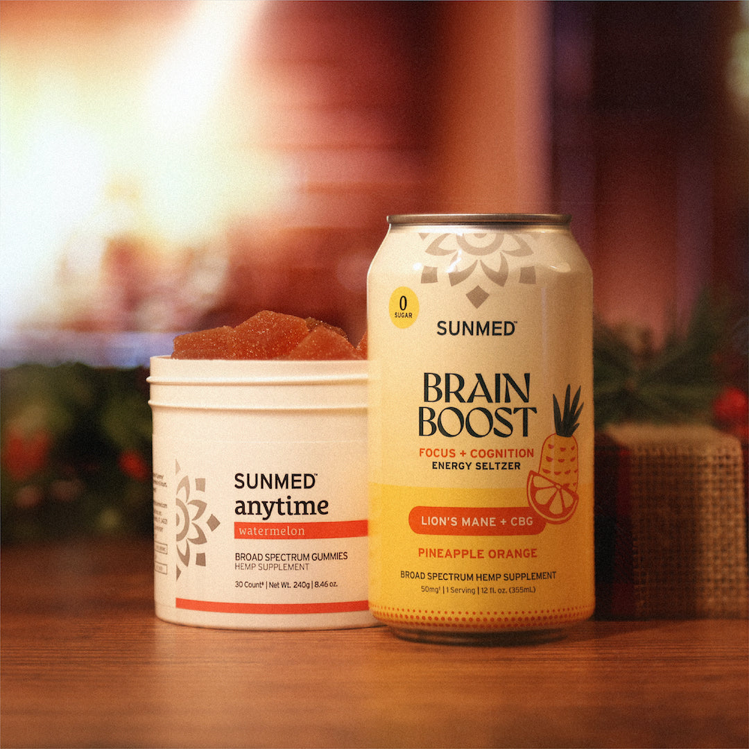 The Anytime Gummies + Brain Boost Seltzer Holiday Bundle by Sunmed CBD rests invitingly on a wooden table.