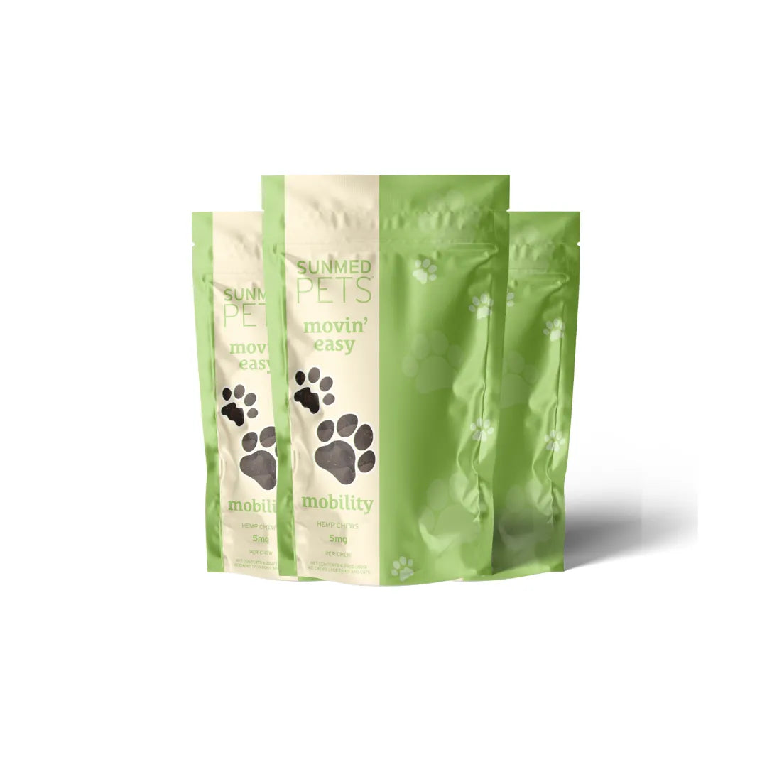 Three green and beige Sunmed CBD *30% Off* - Broad Profile Movin’ Easy Relief Hemp Pet Chews 3-Packs, each standing upright with paw prints and “mobility” text on the front.