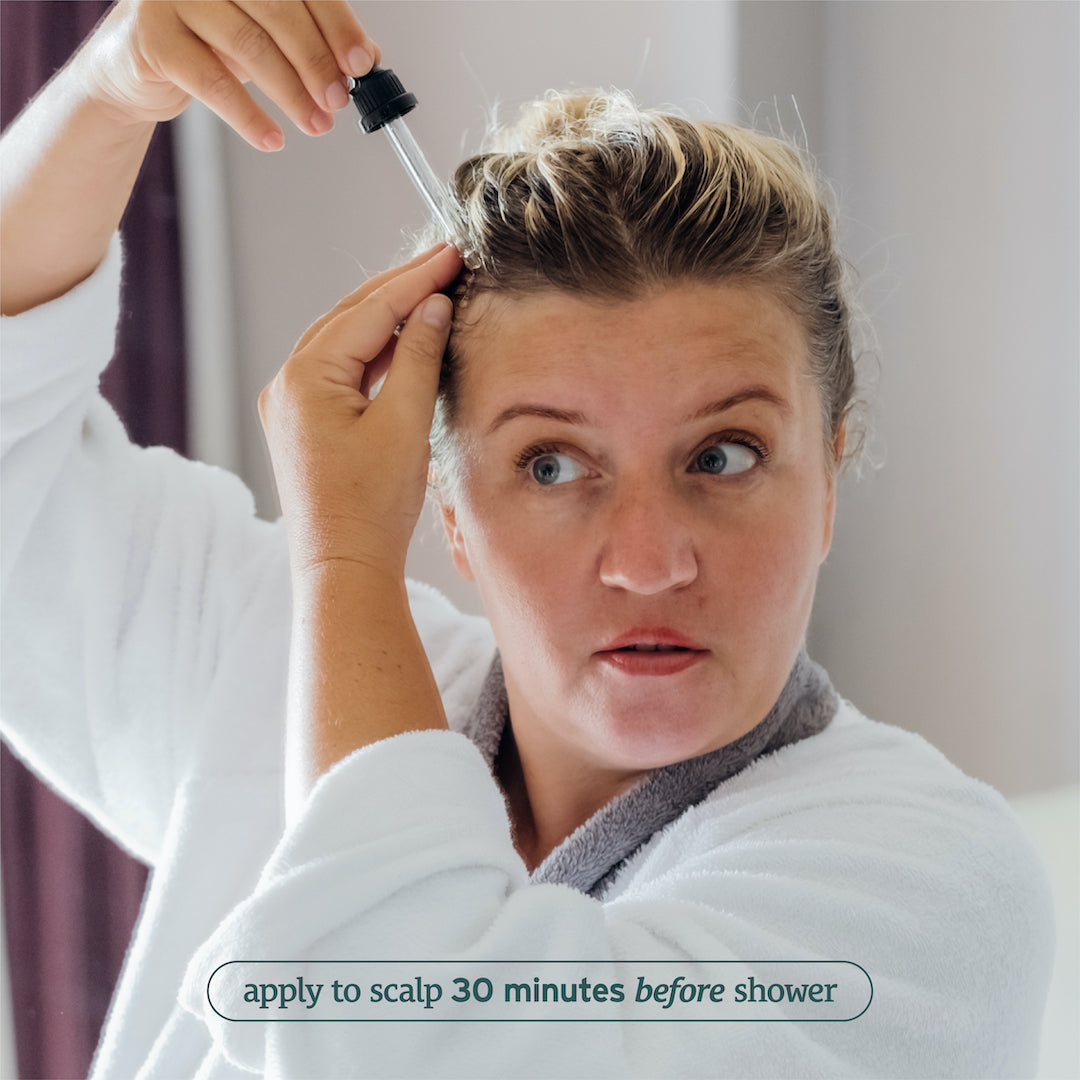 Person applying Sunmed CBD Broad Spectrum Hair + Scalp Oil with a dropper, text reads "apply to scalp 30 minutes before shower for enhanced hair growth.