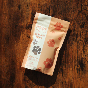 A bag of "Sunmed CBD Broad Spectrum Probiotic CBD Pet Chews" sits on a wooden surface. The bag features paw print designs, highlighting its premium ingredients and broad spectrum probiotic benefits.