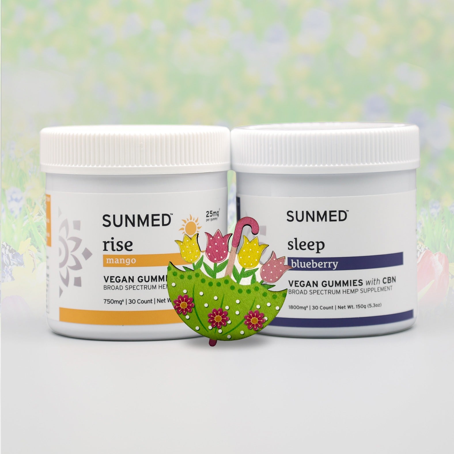 Sunmed CBD Broad Spectrum Sleep + Rise Gummies Bundle features two jars—mango "rise" and blueberry "sleep"—with a painted tulip, ideal for THC-free wellness.