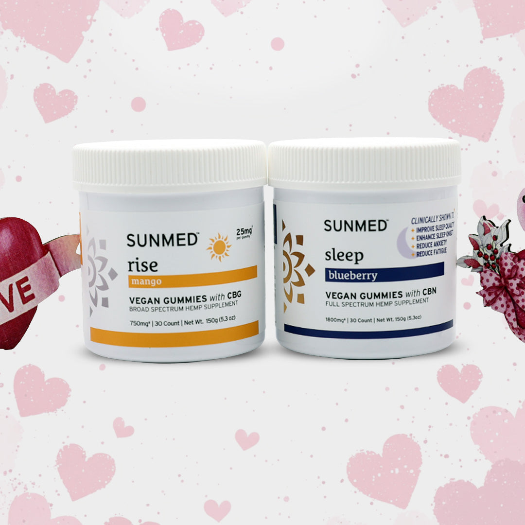 Two jars of Sunmed CBD Full Spectrum Sleep + Rise Gummies Bundle—caffeine-free energy gummies (mango) for morning and sleep gummies (blueberry) for night—sit on a pink heart background.