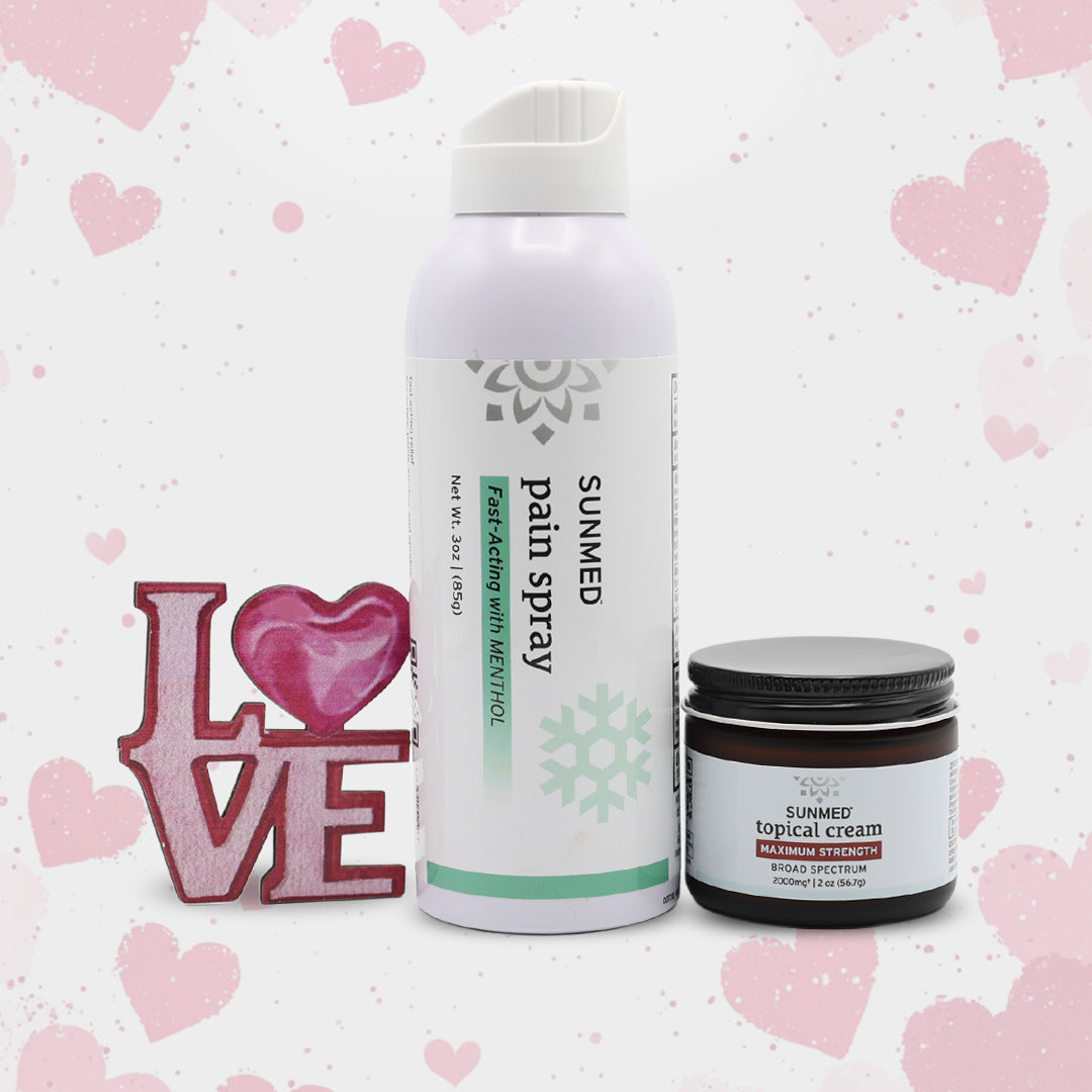 Two Sunmed CBD Broad Spectrum Topical Cream and Menthol Spray Bundle products are pictured with a pink "LOVE" sign on a heart-patterned background.